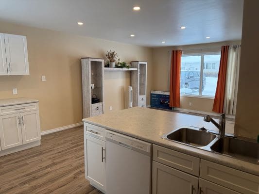 Modern kitchen with island and living area.