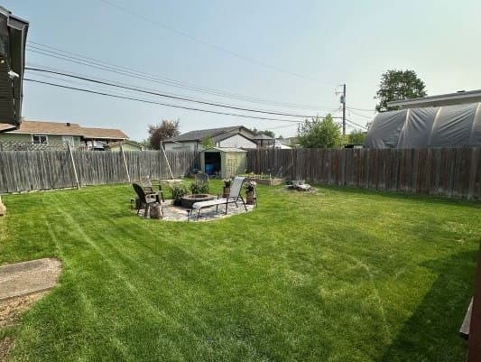 Backyard with fire pit and chairs.
