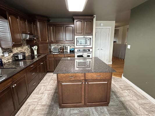 Spacious kitchen with wooden cabinets and island.