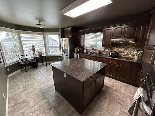 Spacious kitchen with dark wood cabinets.