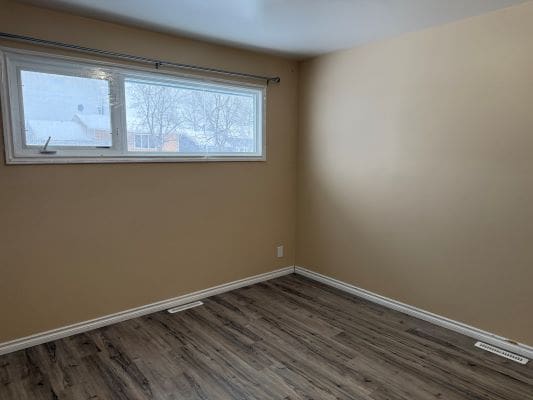 Empty room with beige walls and window.