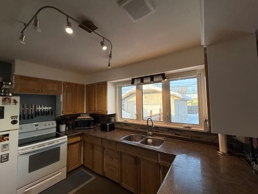 Modern kitchen with wooden cabinets and appliances.
