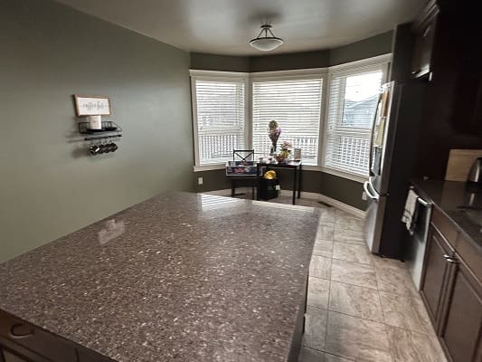 Modern kitchen with large island and windows.