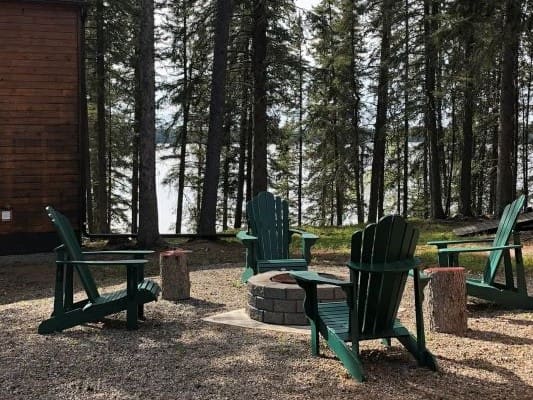 Outdoor seating area with chairs and firepit.