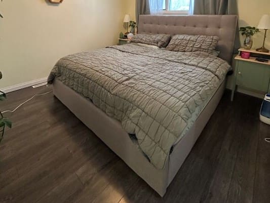 Bedroom with large bed and green bedding.