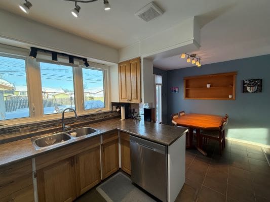 Modern kitchen and dining area with window.