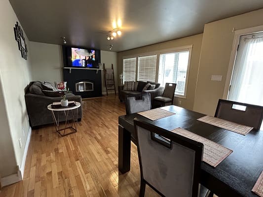 Modern living room with dining area and TV.