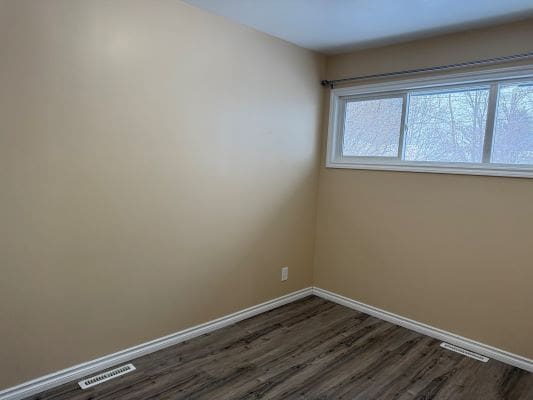 Empty room with beige walls and window.