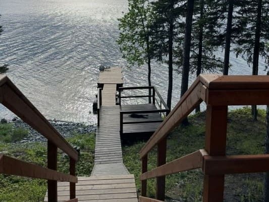 Wooden dock leading to a calm lake.