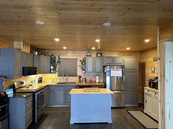 Modern kitchen with wooden ceiling and island.
