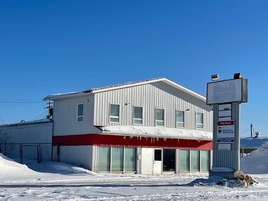 Two-story building with snow and icicles.
