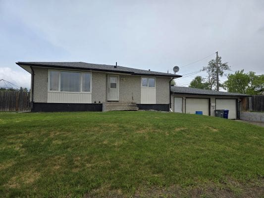 Single-story house with a grassy yard.
