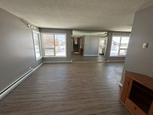 Spacious living room with large windows.