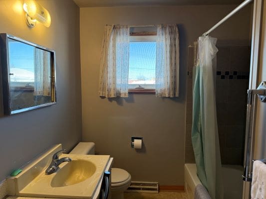 Small bathroom with window and shower.