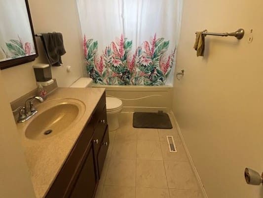 Bathroom with floral shower curtain and sink.
