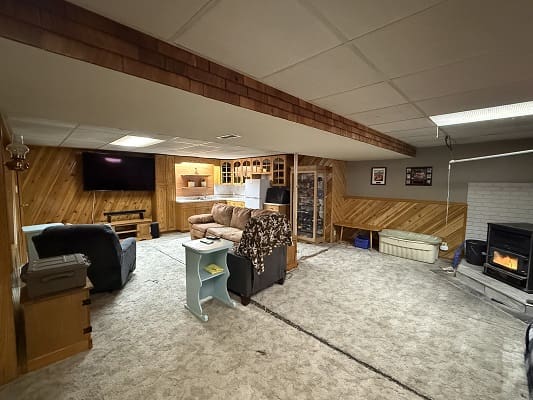 Cozy basement living room with fireplace.