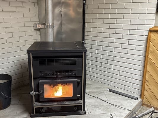 Wood-burning stove with visible flames.