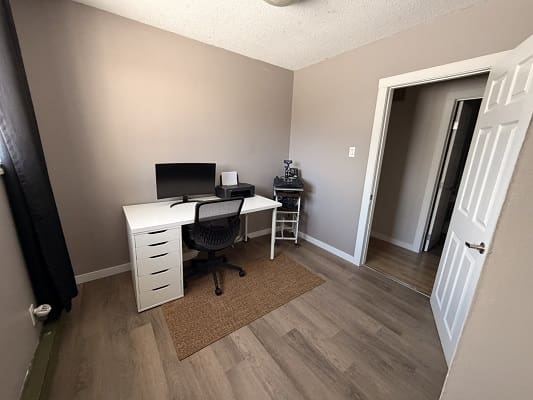 Minimalist home office with desk and chair.