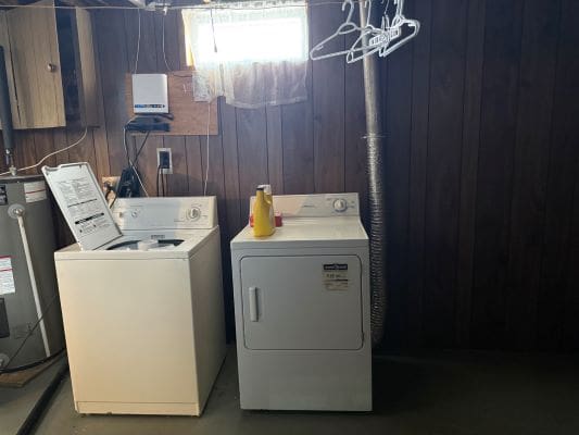 Basement laundry room with washer and dryer.