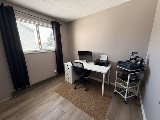 Minimalist home office with desk and chair.