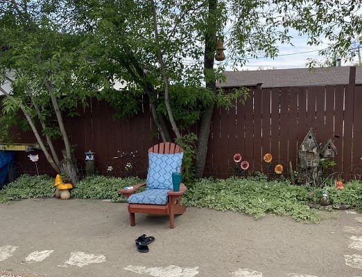 Garden scene with chair and decorations.