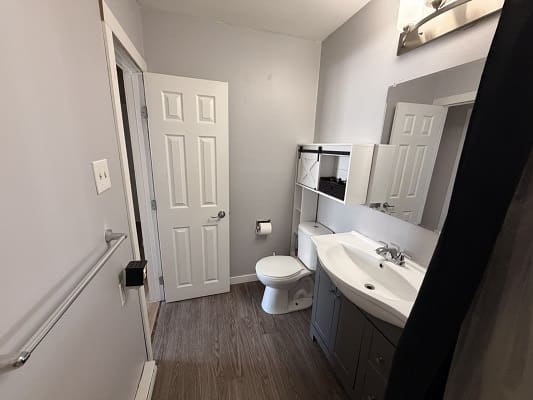 Small modern bathroom with white fixtures.