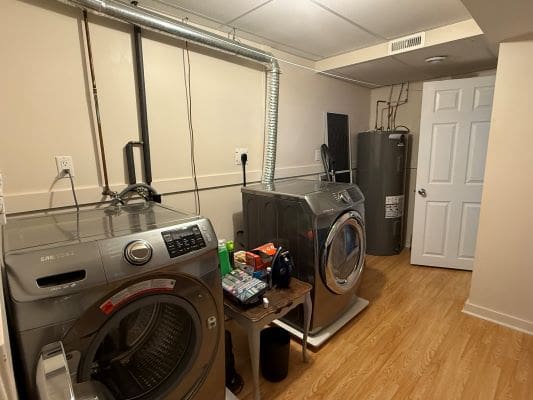 Laundry room with washer, dryer, and heater.