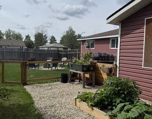 Backyard with garden and outdoor seating area.