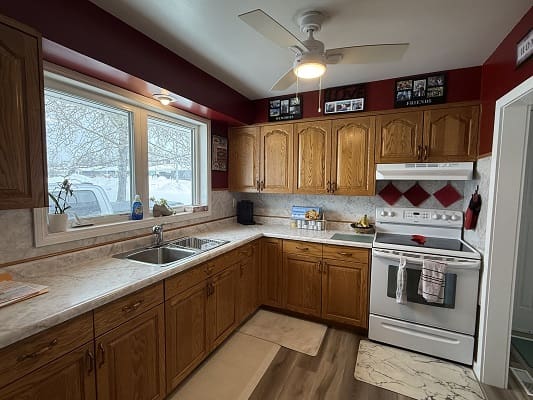 Traditional kitchen with wooden cabinets and stove.
