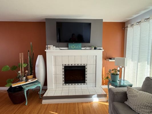 Modern living room with TV and fireplace.