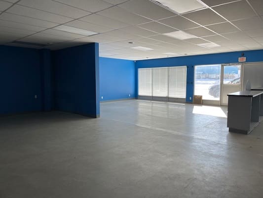 Empty room with blue walls and windows.
