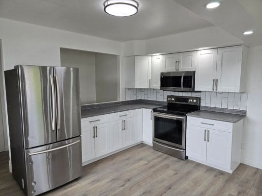 Modern kitchen with stainless steel appliances.