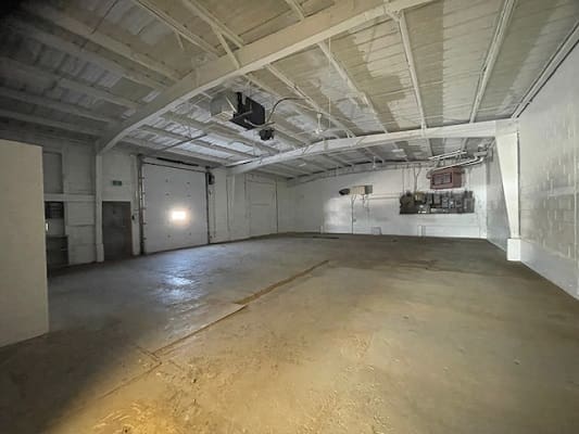 Empty industrial warehouse with concrete floor.
