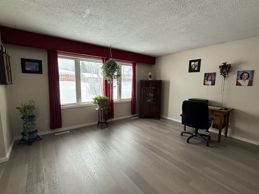 Minimalist room with desk and large window.