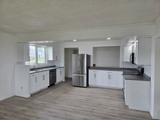 Modern kitchen with stainless steel appliances.