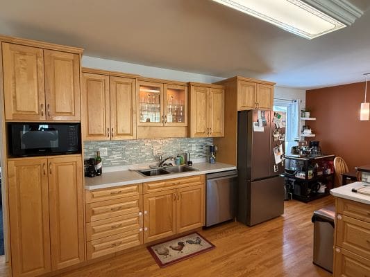 Wooden kitchen cabinets with stainless steel appliances.