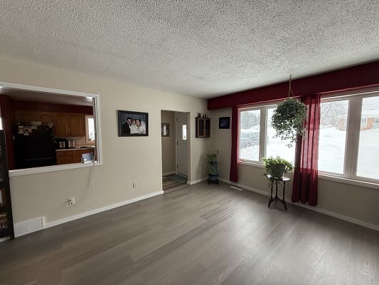 Spacious living room with large, bright windows.
