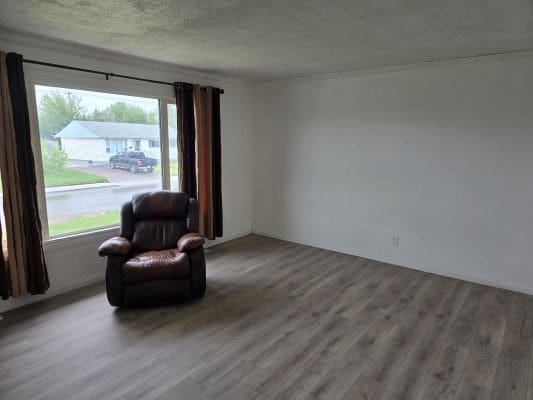 Empty room with armchair near window.