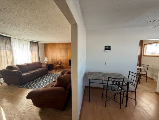 Open living and dining area with furniture.
