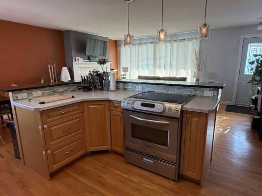 Modern kitchen with island and oven.