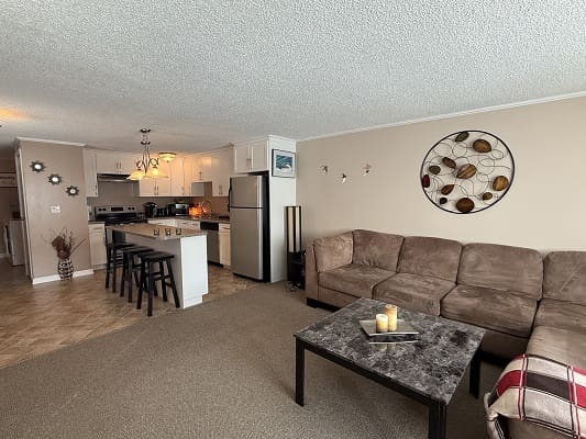 Modern open-plan living room and kitchen area.