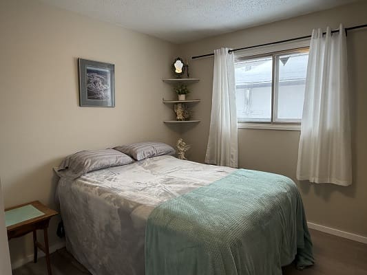 Cozy bedroom with bed and window.