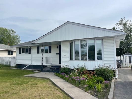 White house with front garden and pathway.