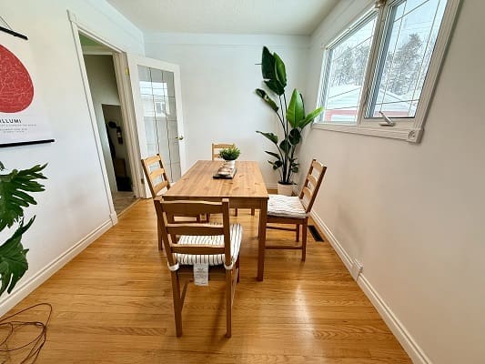 Dining room with wooden table and chairs.