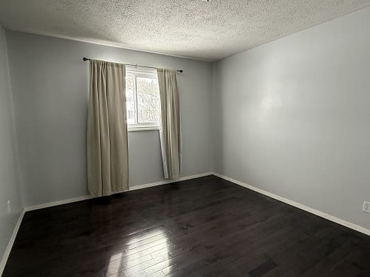 Empty room with window and curtains.