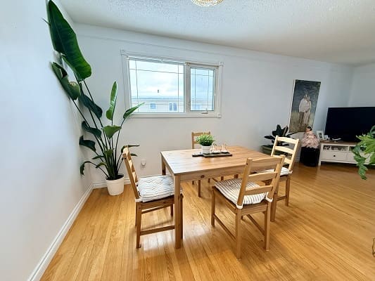 Minimalist dining room with wooden table set.
