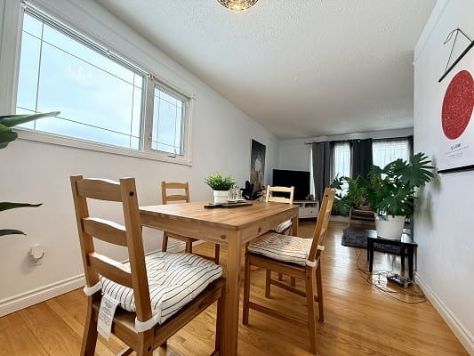 Dining area with wooden table and chairs.