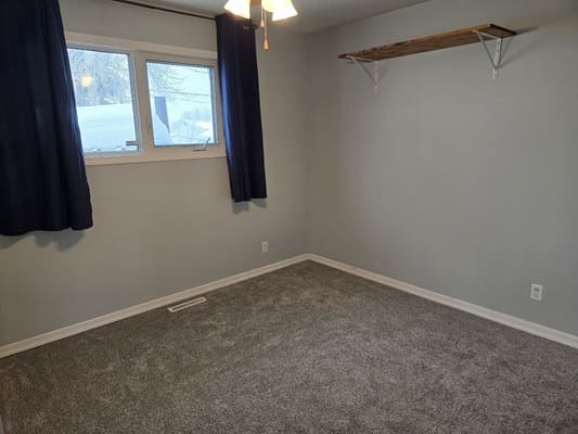 Empty room with carpet and window.