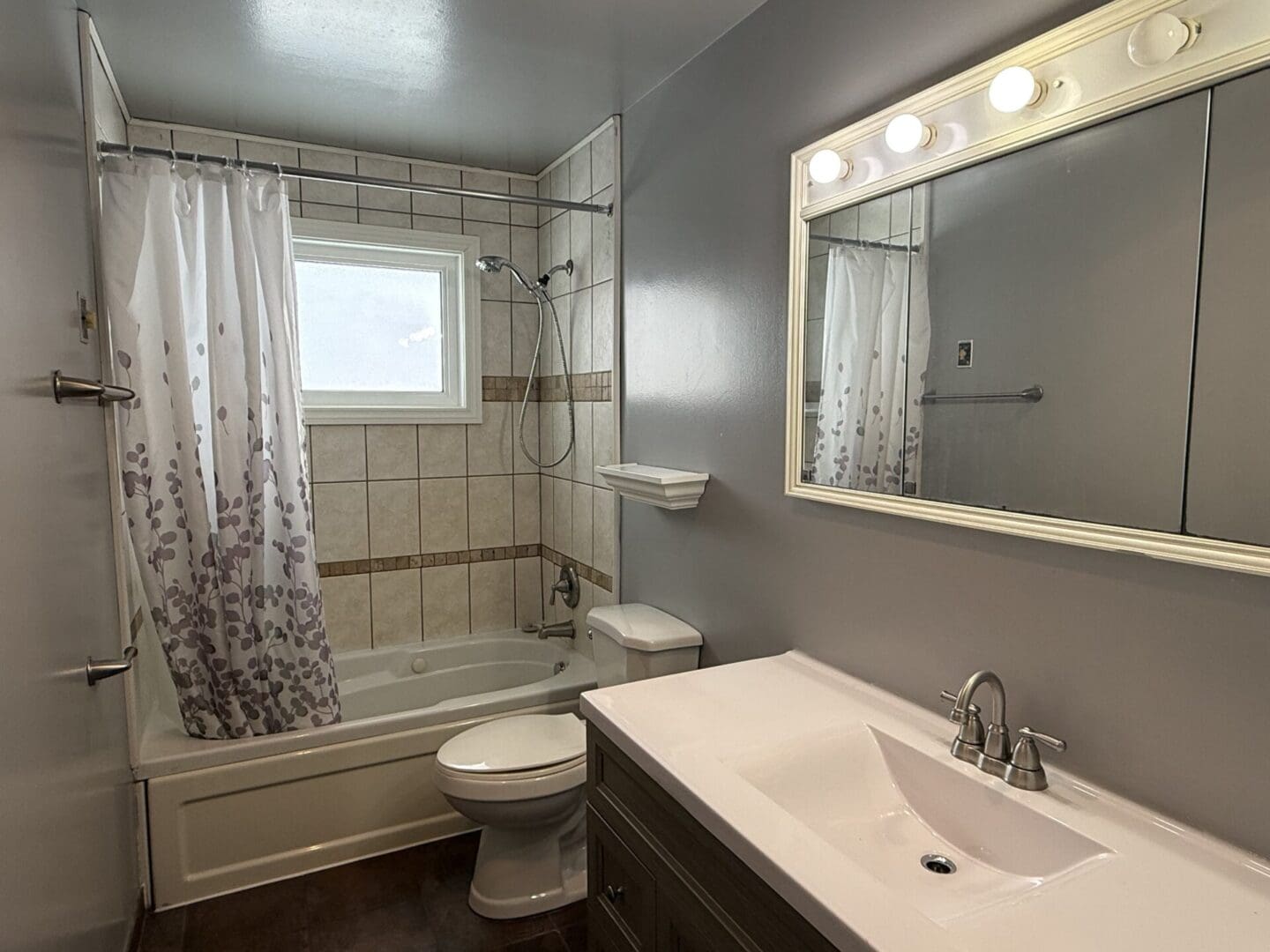Modern bathroom with shower and vanity mirror.