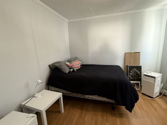 Minimalist bedroom with bed and side table.
